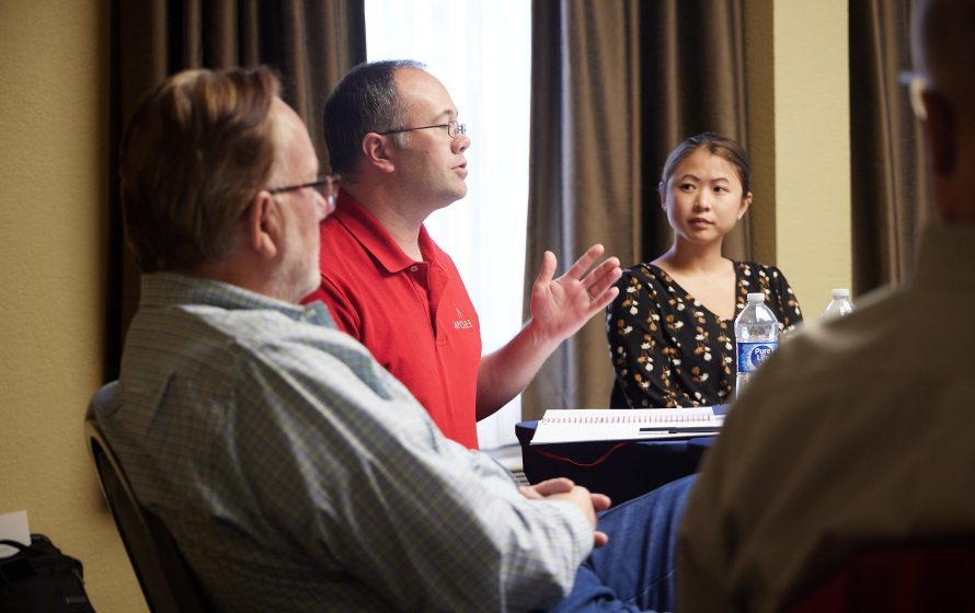 Employees discussing around a table