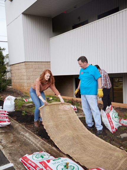 Apogee employees gardening at Raleigh office's city garden annual planting day