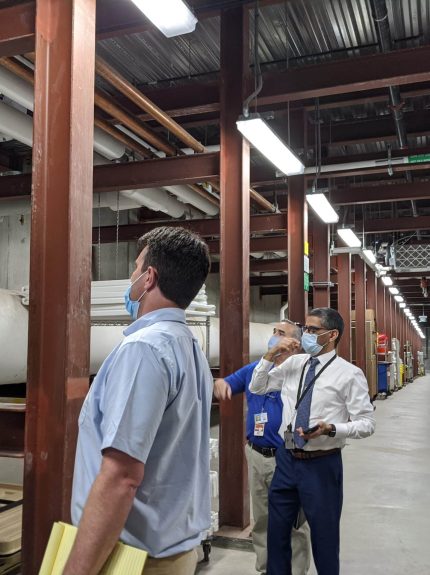 Apogee employees looking at pipes