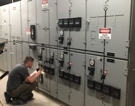 Apogee employee working on electrical panel