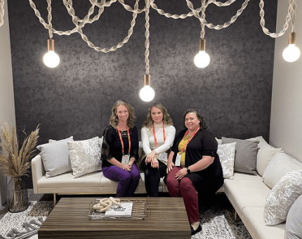 Three women sitting on a couch