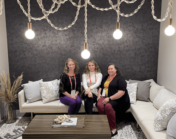 Three women sitting on a couch